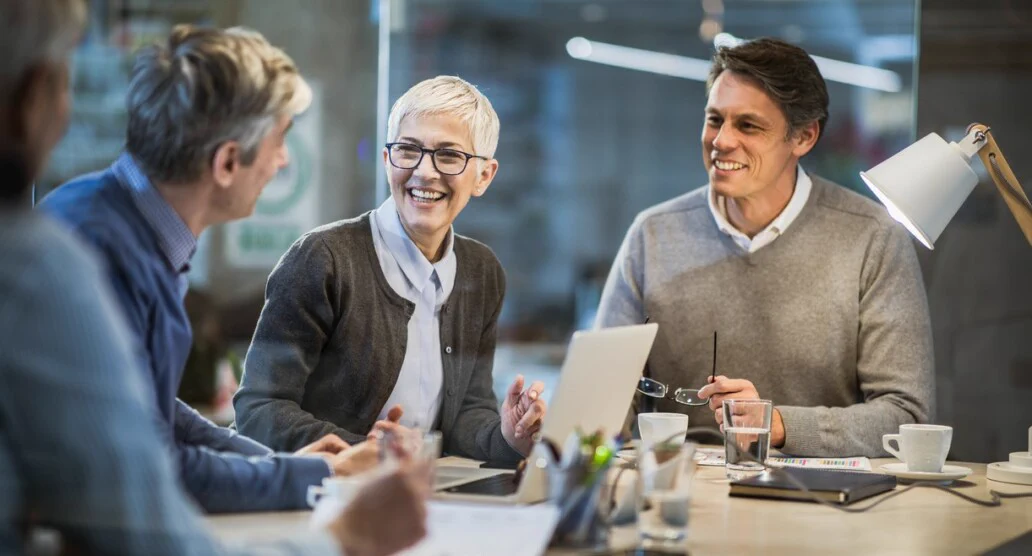 A team reviewing expense reports around a meeting table